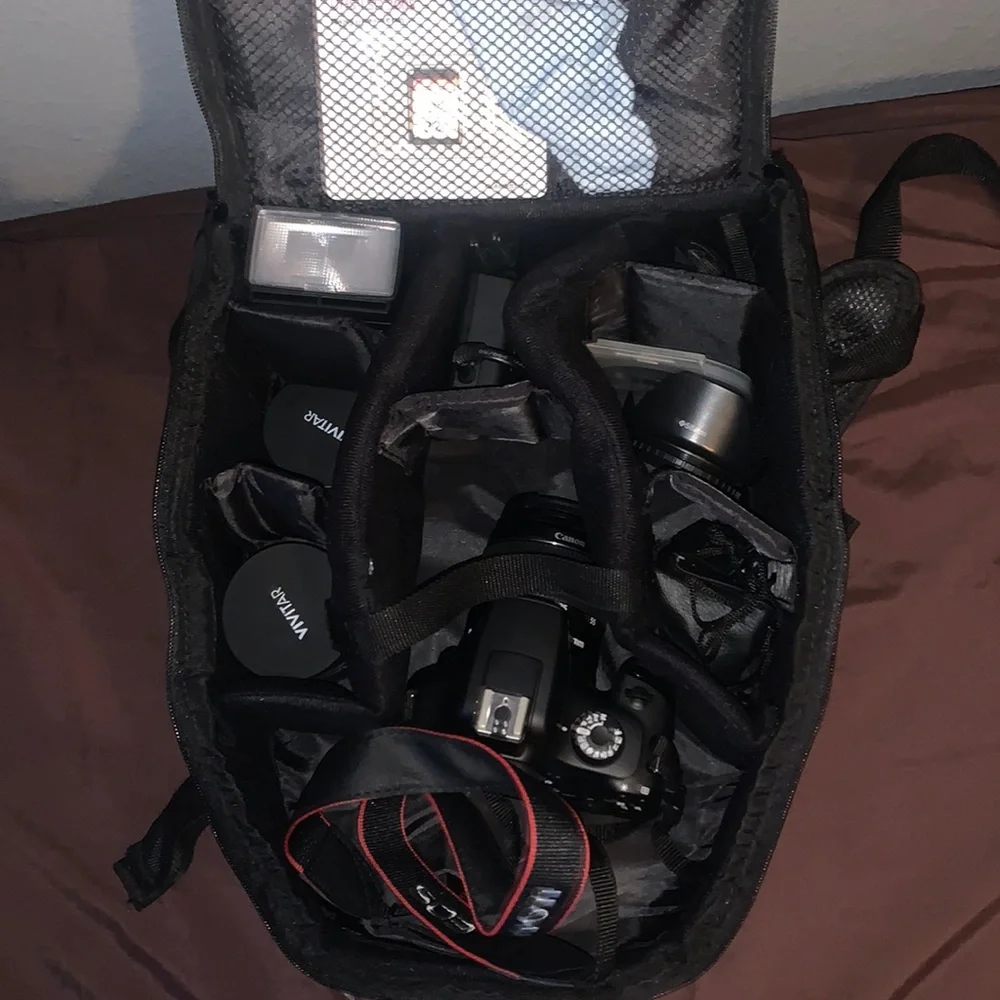 Selling a Canon Rebel T100 Camera with a lot of accessories and a backpack.